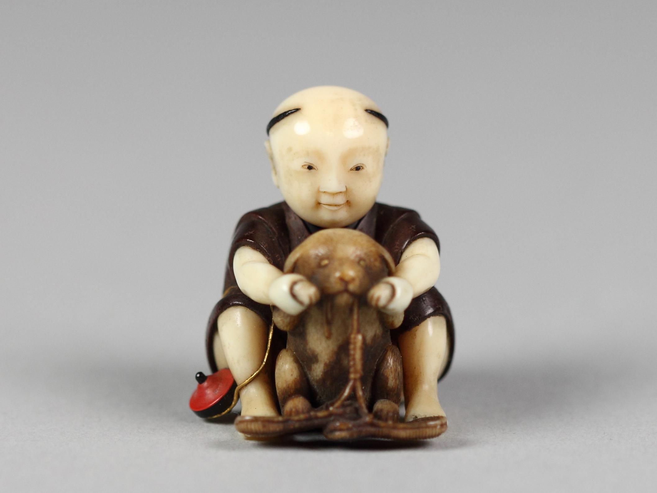 Netsuke of Boy Playing with a Dog